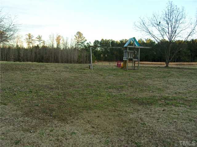 2030 Pilot-Riley Road Zebulon, NC 27597 - Photo 23 of 25 a backyard of a house with lots of green space