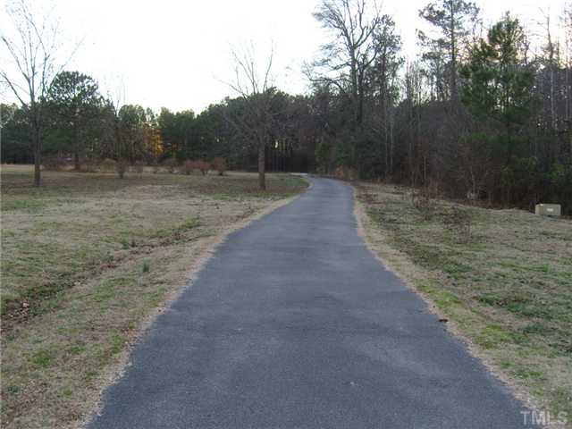 2030 Pilot-Riley Road Zebulon, NC 27597 - Photo 25 of 25 a view of a dirt road with a building in the background
