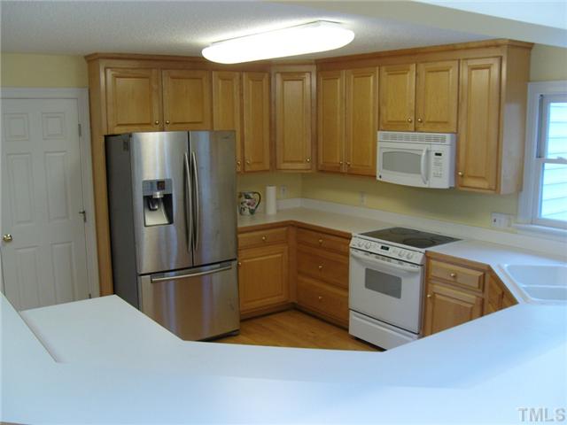 2030 Pilot-Riley Road Zebulon, NC 27597 - Photo 9 of 25 a kitchen with granite countertop a refrigerator and a sink