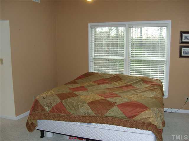 2030 Pilot-Riley Road Zebulon, NC 27597 - Photo 10 of 25 a bed sitting in a bedroom next to a window