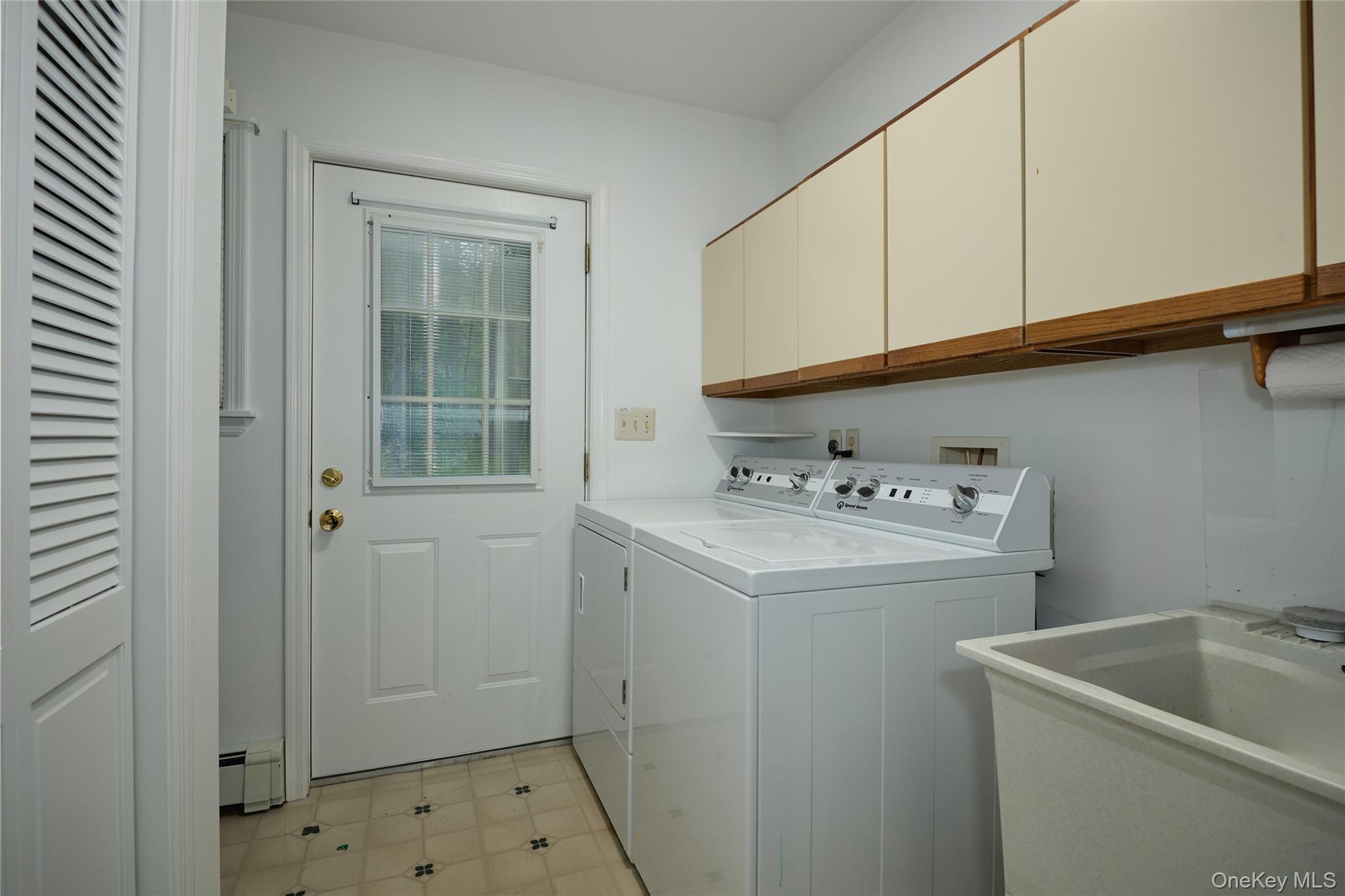 34 Maple Brook Road Tuxedo Park, NY 10987 - Photo 18 of 25 a utility room with cabinets washer and dryer