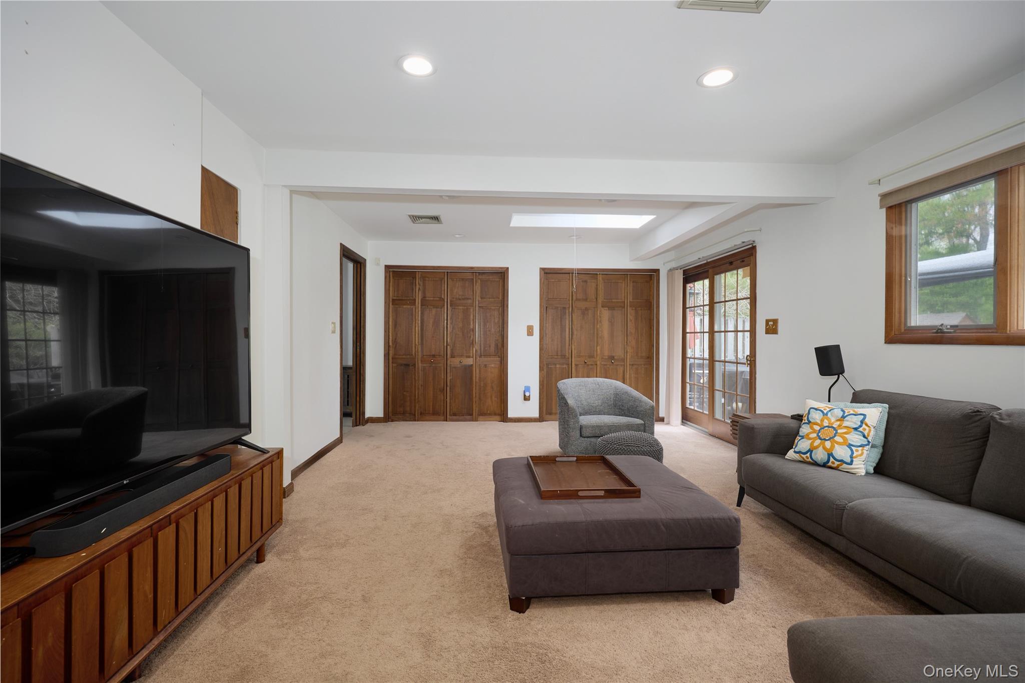 34 Maple Brook Road Tuxedo Park, NY 10987 - Photo 21 of 25 a living room with furniture and a flat screen tv