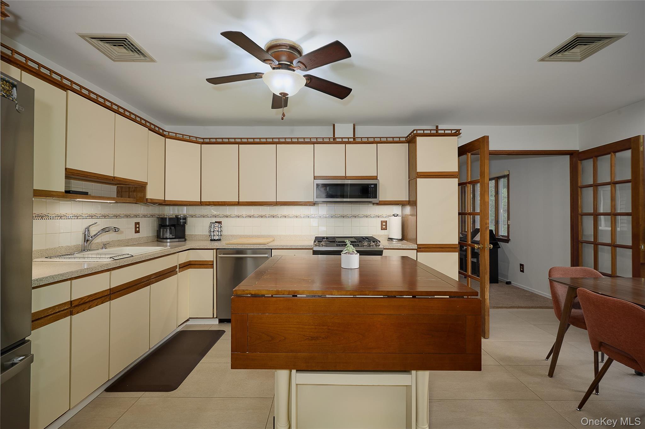34 Maple Brook Road Tuxedo Park, NY 10987 - Photo 5 of 25 a kitchen with kitchen island granite countertop a sink window and stainless steel appliances