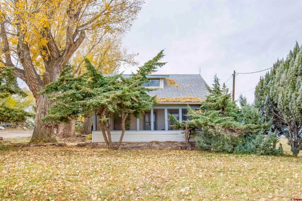 a hallway with wooden floor and windows