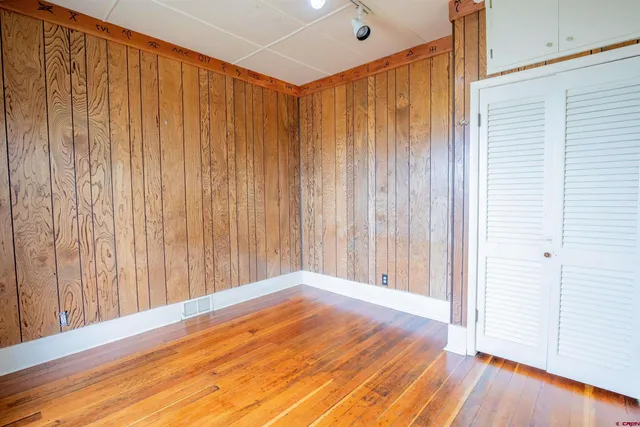 a view of a room with a wooden door