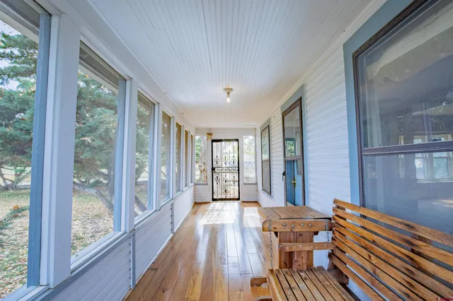 a outdoor space with wooden floor and windows