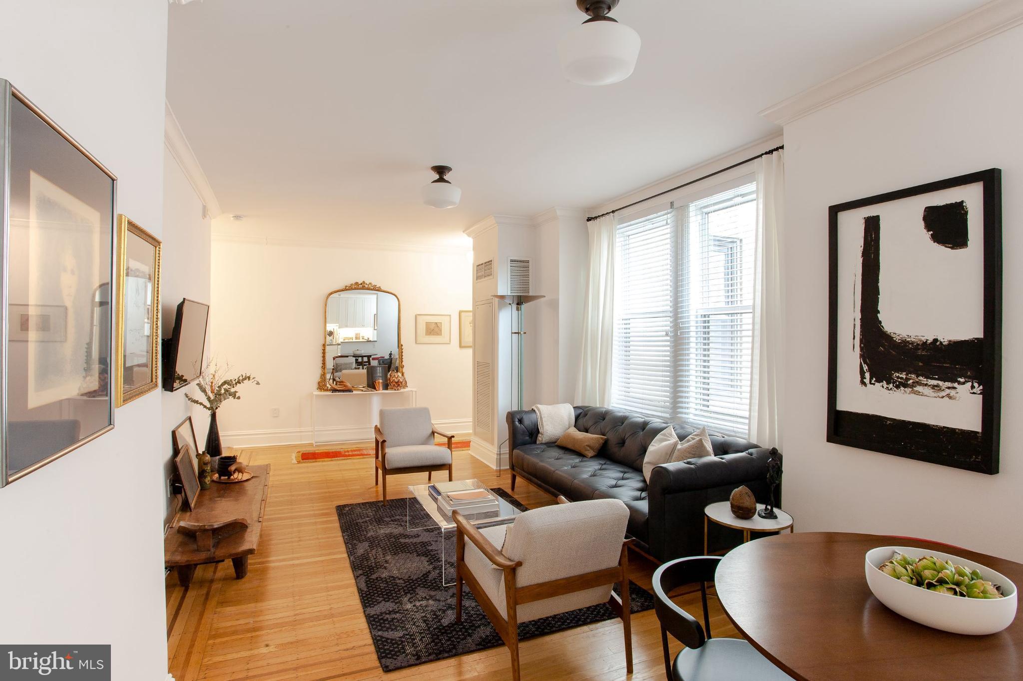 1520-28 Spruce Street, Unit 202 Philadelphia, PA 19102 - Photo 11 of 24 a living room with furniture and a window