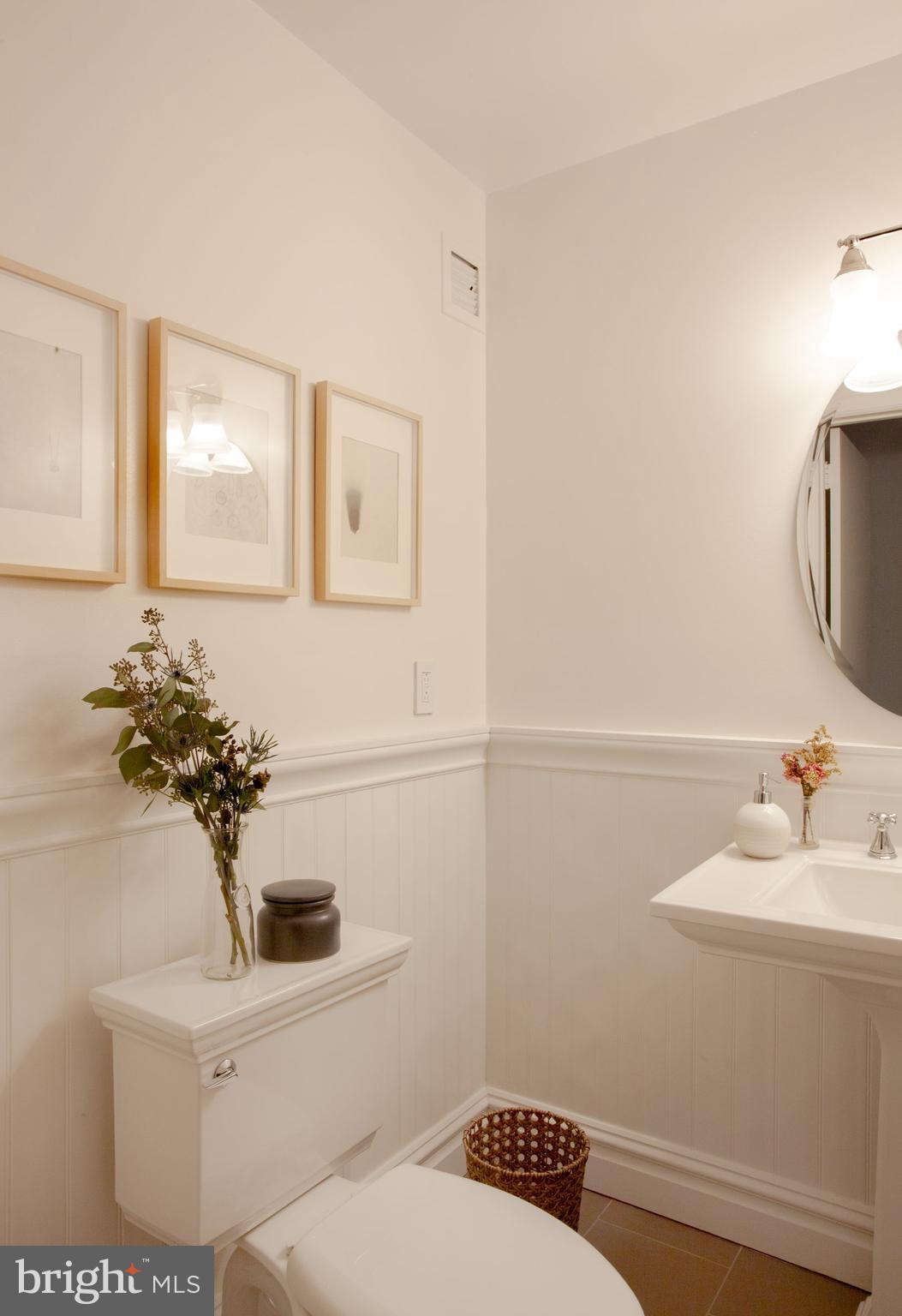 1520-28 Spruce Street, Unit 202 Philadelphia, PA 19102 - Photo 3 of 24 a bathroom with a sink a toilet and mirror