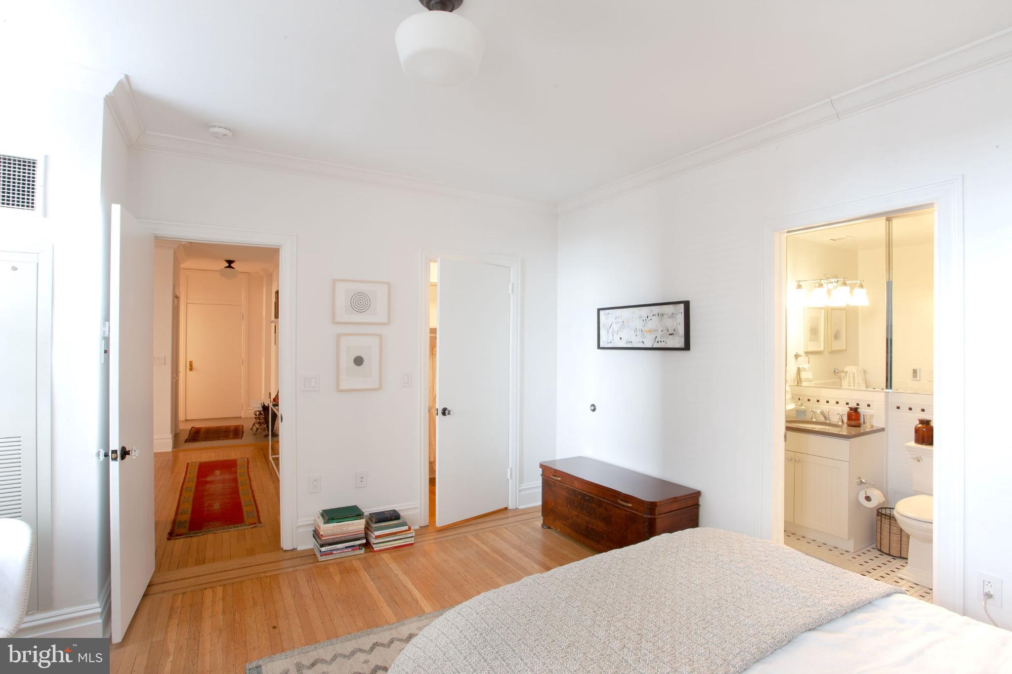 1520-28 Spruce Street, Unit 202 Philadelphia, PA 19102 - Photo 5 of 24 a bedroom with a bed and wooden floor