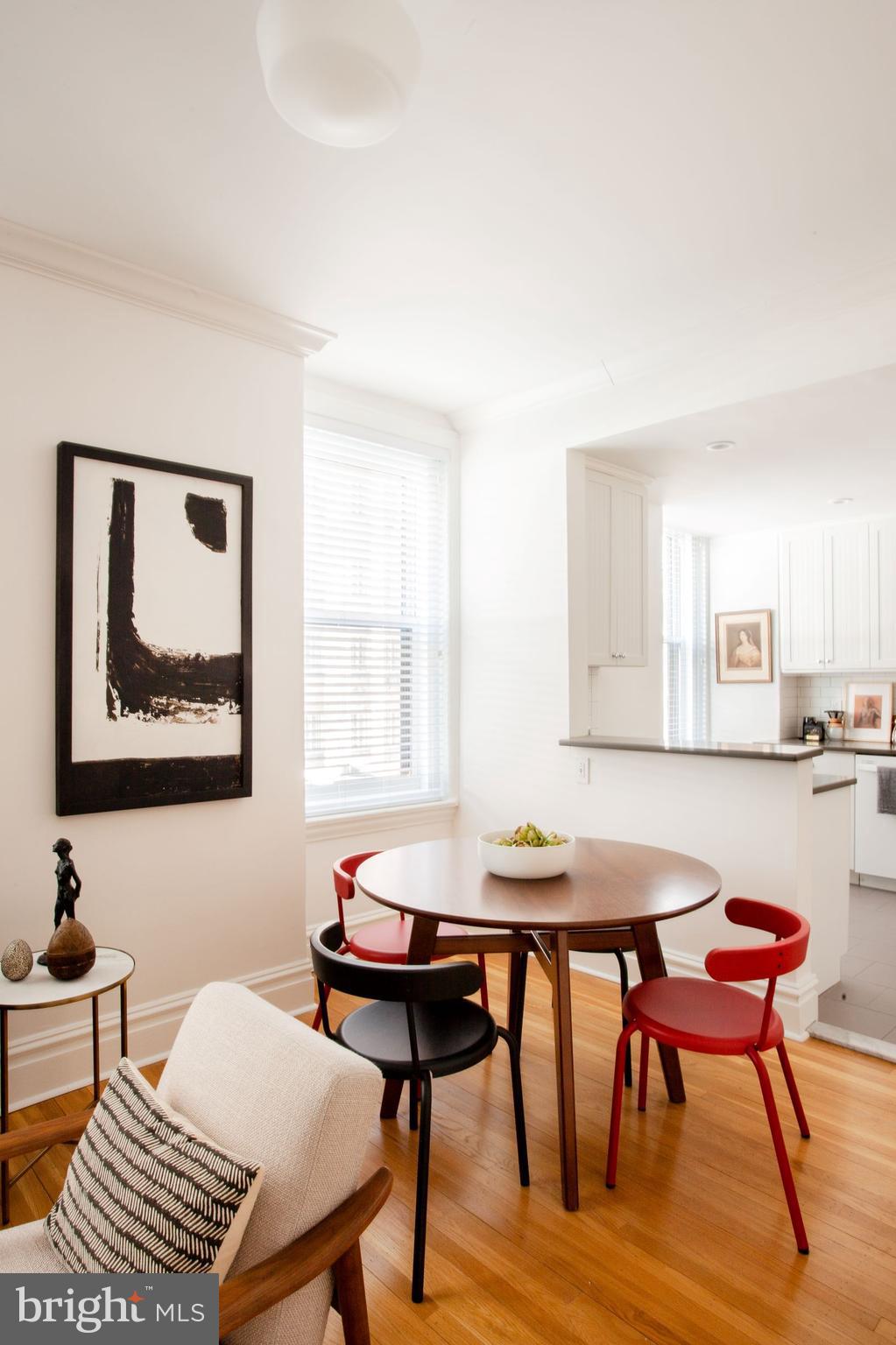 1520-28 Spruce Street, Unit 202 Philadelphia, PA 19102 - Photo 7 of 24 a view of a dining room with furniture and wooden floor