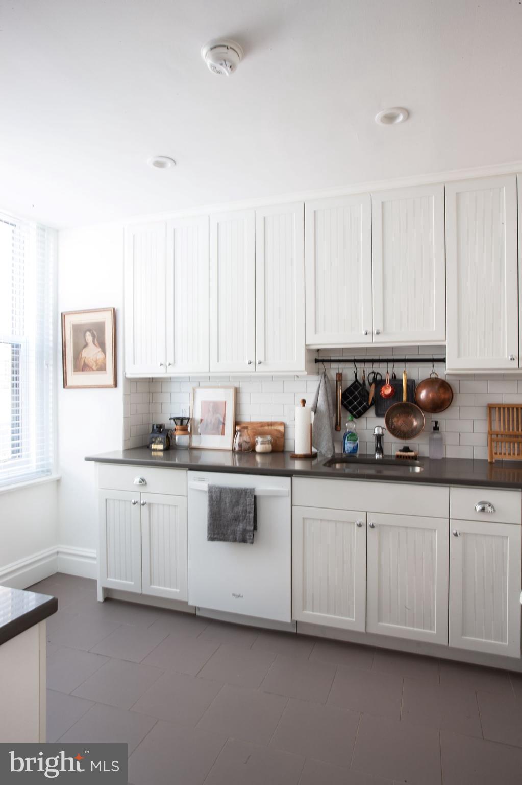 1520-28 Spruce Street, Unit 202 Philadelphia, PA 19102 - Photo 8 of 24 a kitchen with granite countertop white cabinets and sink