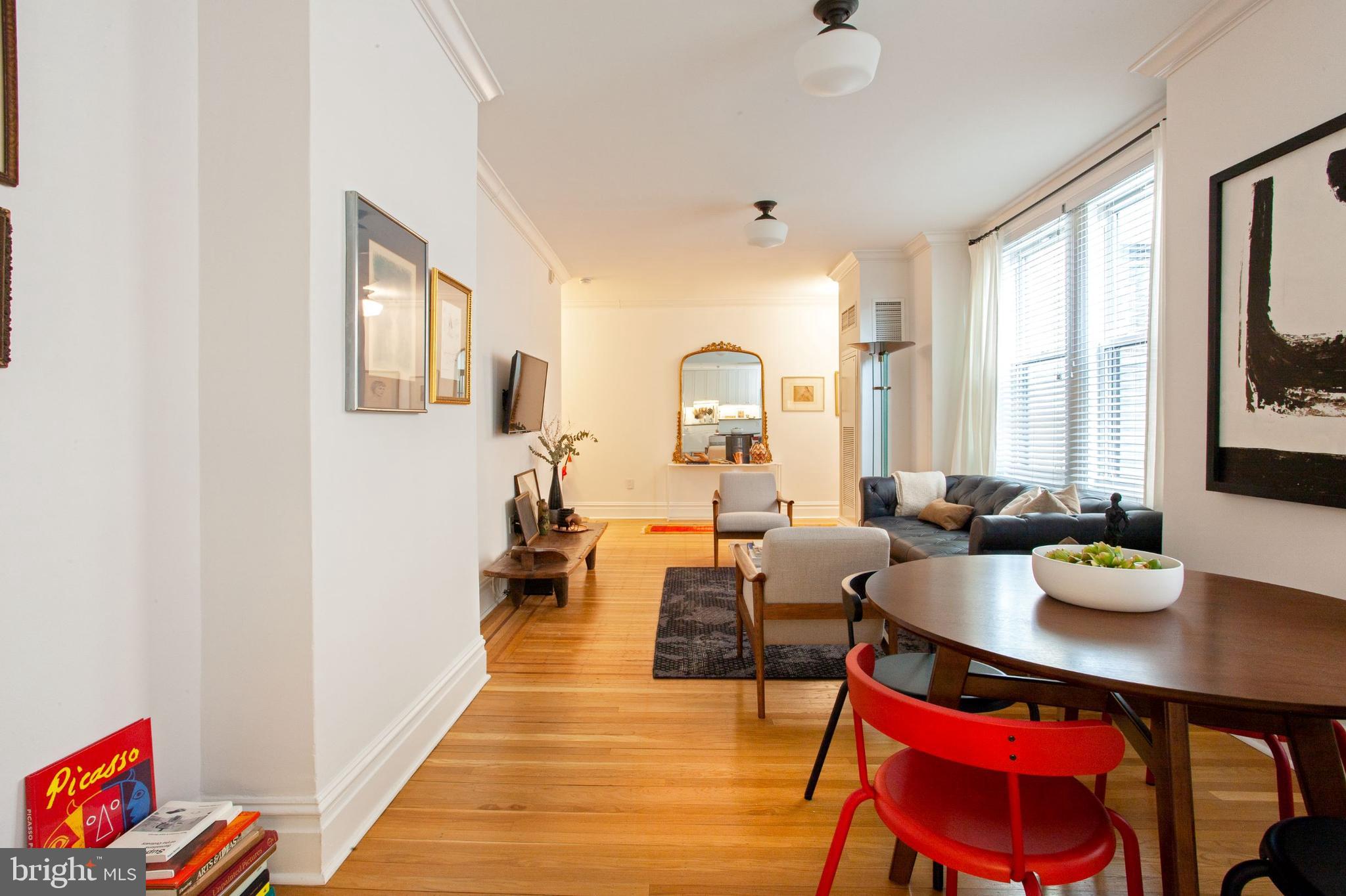 1520-28 Spruce Street, Unit 202 Philadelphia, PA 19102 - Photo 10 of 24 a living room with furniture and a window