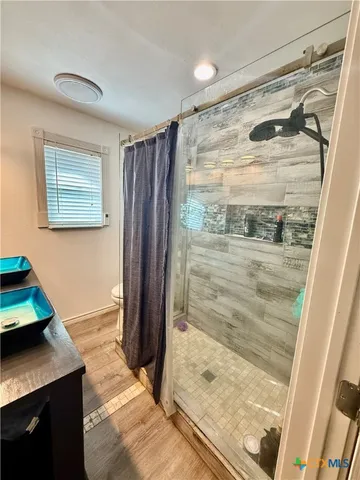 a bathroom with a shower and a tub