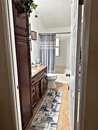 a bedroom with a bed and dresser with mirror