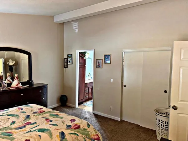 a bedroom with a bed and dresser