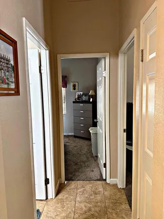 a bedroom with a bed and a potted plant