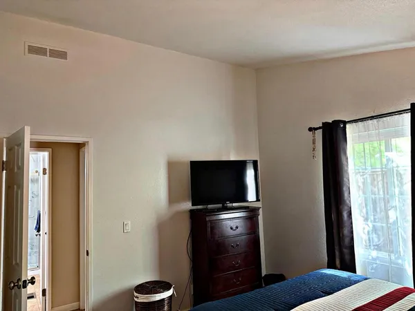 a bedroom with a bed and a window
