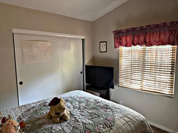 a bathroom with a granite countertop sink toilet and mirror