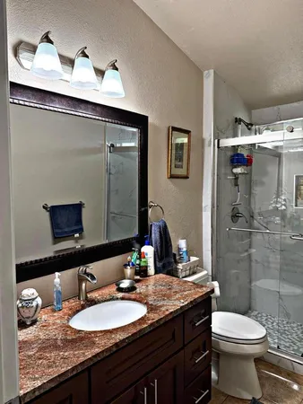 a bedroom with a bed and a large mirror
