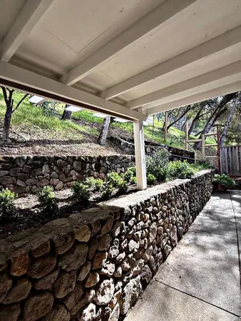 a view of a yard with wooden fence