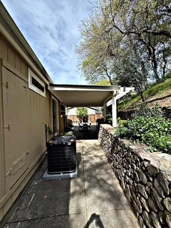 a living room with patio furniture and a floor to ceiling window