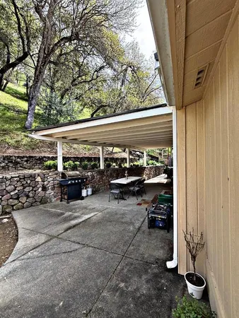 a view of a house with a porch and furniture