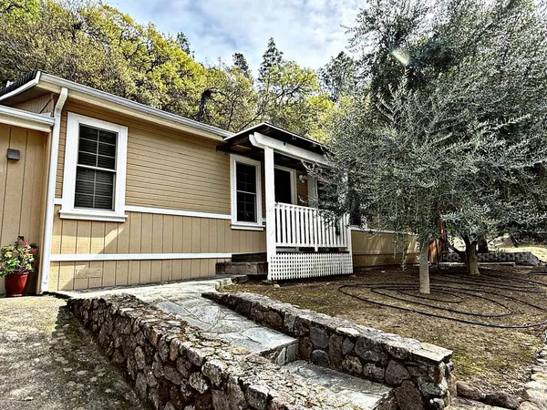 a side view of a house with a fence