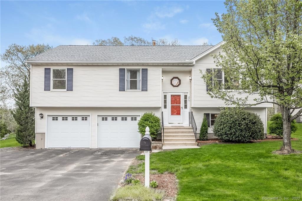 275 Stoddard Road Waterbury, CT 06708 - Photo 1 of 1 a front view of a house with a garden and yard