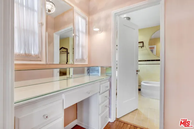 a bathroom with a shower sink and mirror
