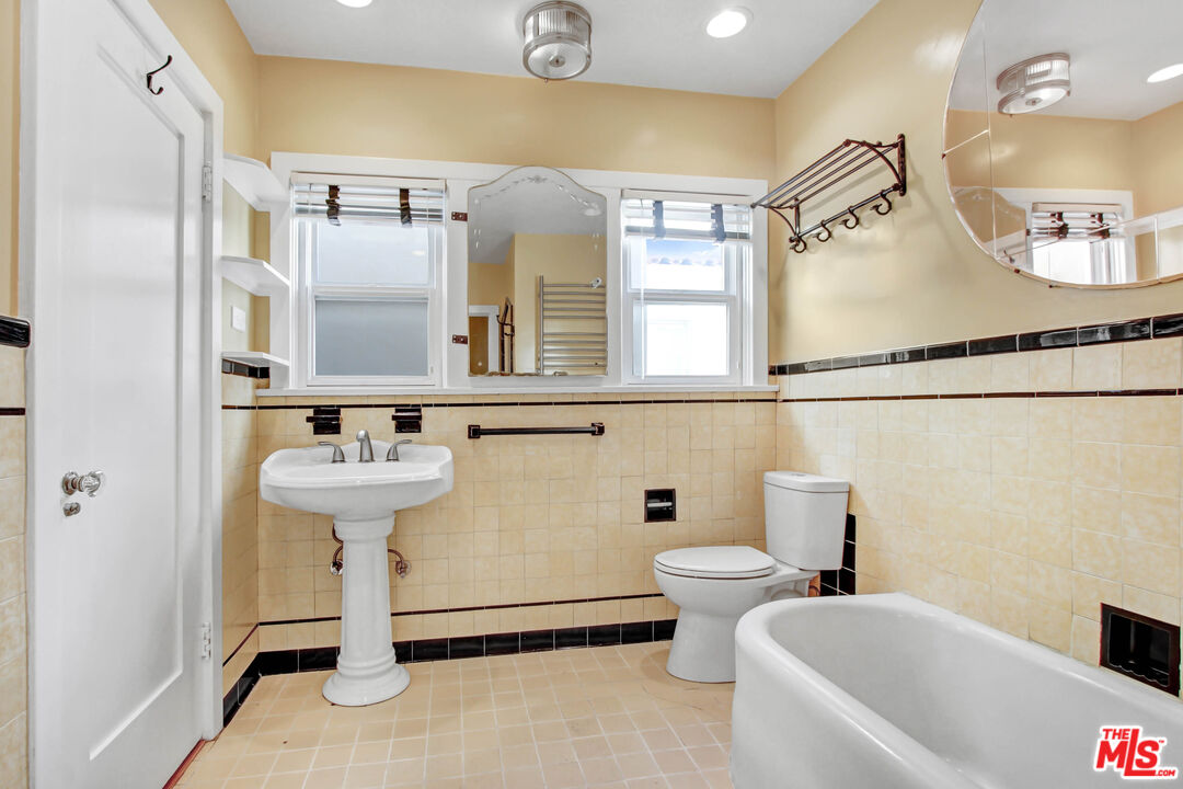 1020 Hi Point Street, Unit 1020 Los Angeles, CA 90035 - Photo 13 of 18 a bathroom with a sink and a mirror