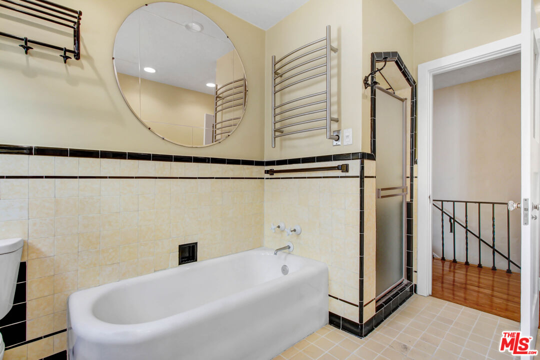 1020 Hi Point Street, Unit 1020 Los Angeles, CA 90035 - Photo 14 of 18 a bathroom with a bathtub and a shower