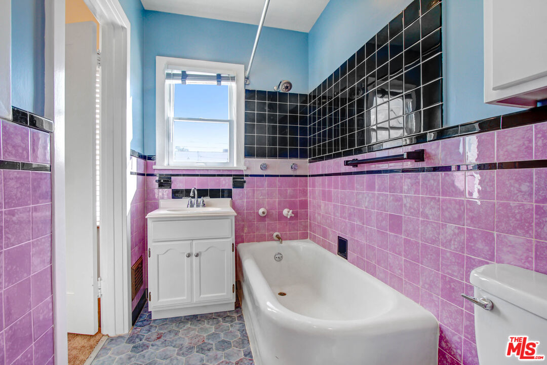 1020 Hi Point Street, Unit 1020 Los Angeles, CA 90035 - Photo 15 of 18 a bathroom with a bathtub sink and toilet