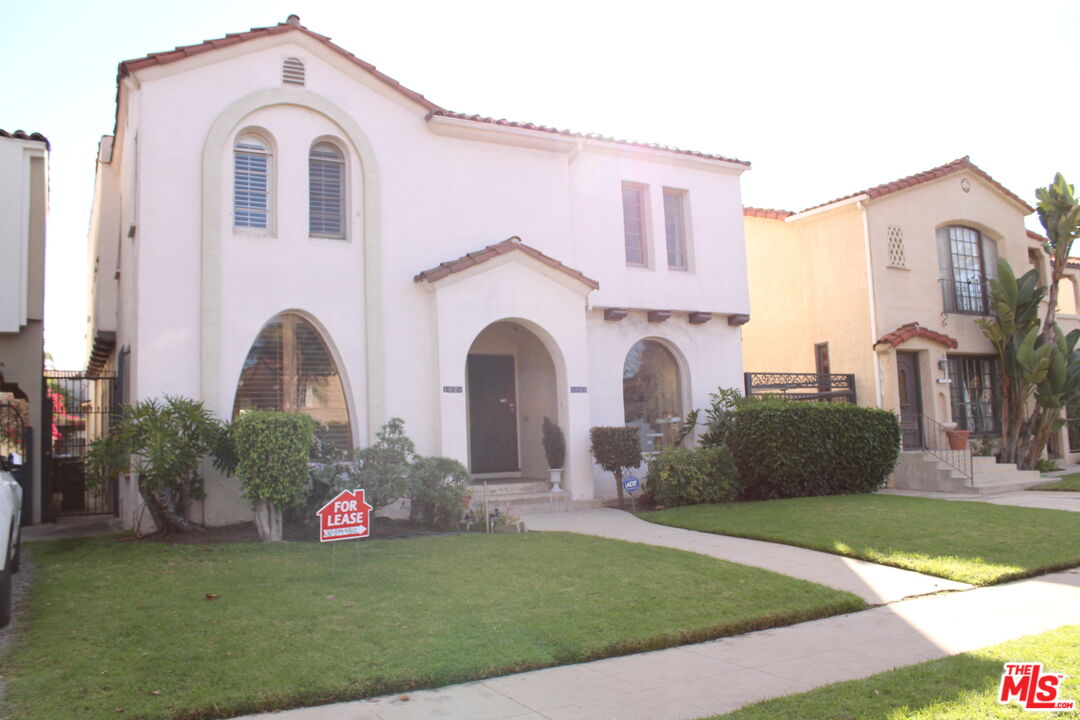 1020 Hi Point Street, Unit 1020 Los Angeles, CA 90035 - Photo 18 of 37 a front view of a house with garden