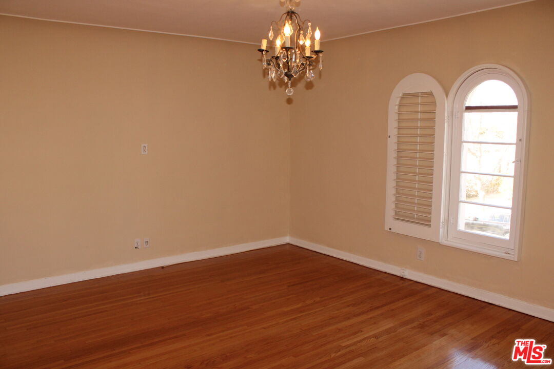1020 Hi Point Street, Unit 1020 Los Angeles, CA 90035 - Photo 35 of 37 a view of a livingroom with wooden floor and a chandelier