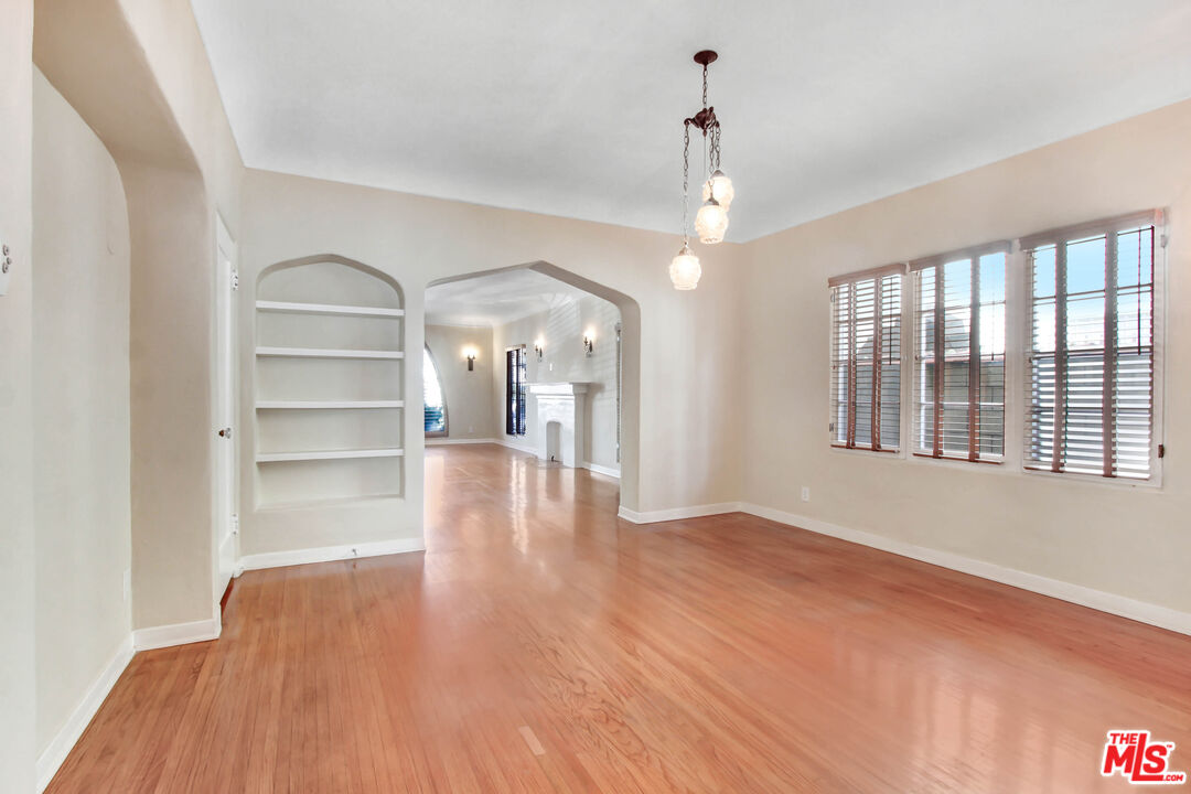 1020 Hi Point Street, Unit 1020 Los Angeles, CA 90035 - Photo 6 of 18 a view of an empty room with wooden floor and a window