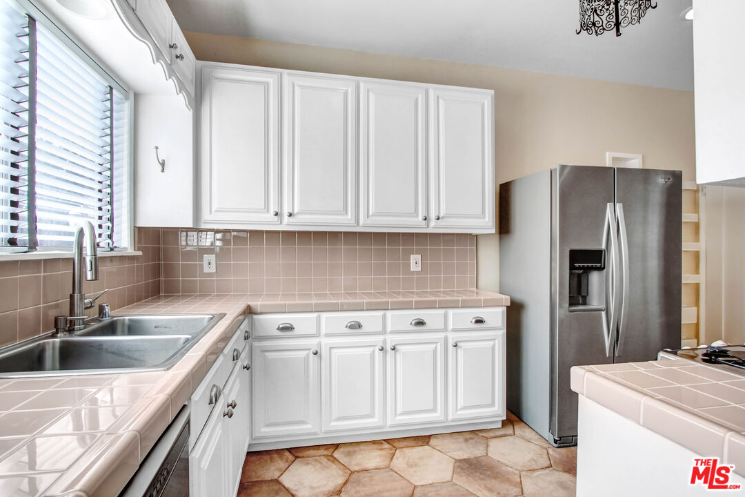 1020 Hi Point Street, Unit 1020 Los Angeles, CA 90035 - Photo 7 of 18 a kitchen with stainless steel appliances granite countertop a sink stove and refrigerator