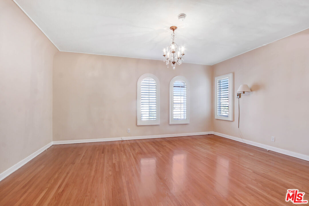 1020 Hi Point Street, Unit 1020 Los Angeles, CA 90035 - Photo 9 of 18 a view of an empty room with a window and wooden floor