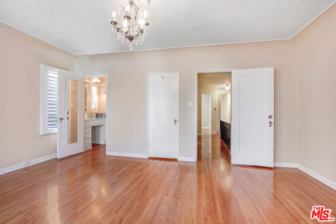 1020 Hi Point Street, Unit 1020 Los Angeles, CA 90035 - Photo 10 of 18 a view of an empty room with wooden floor
