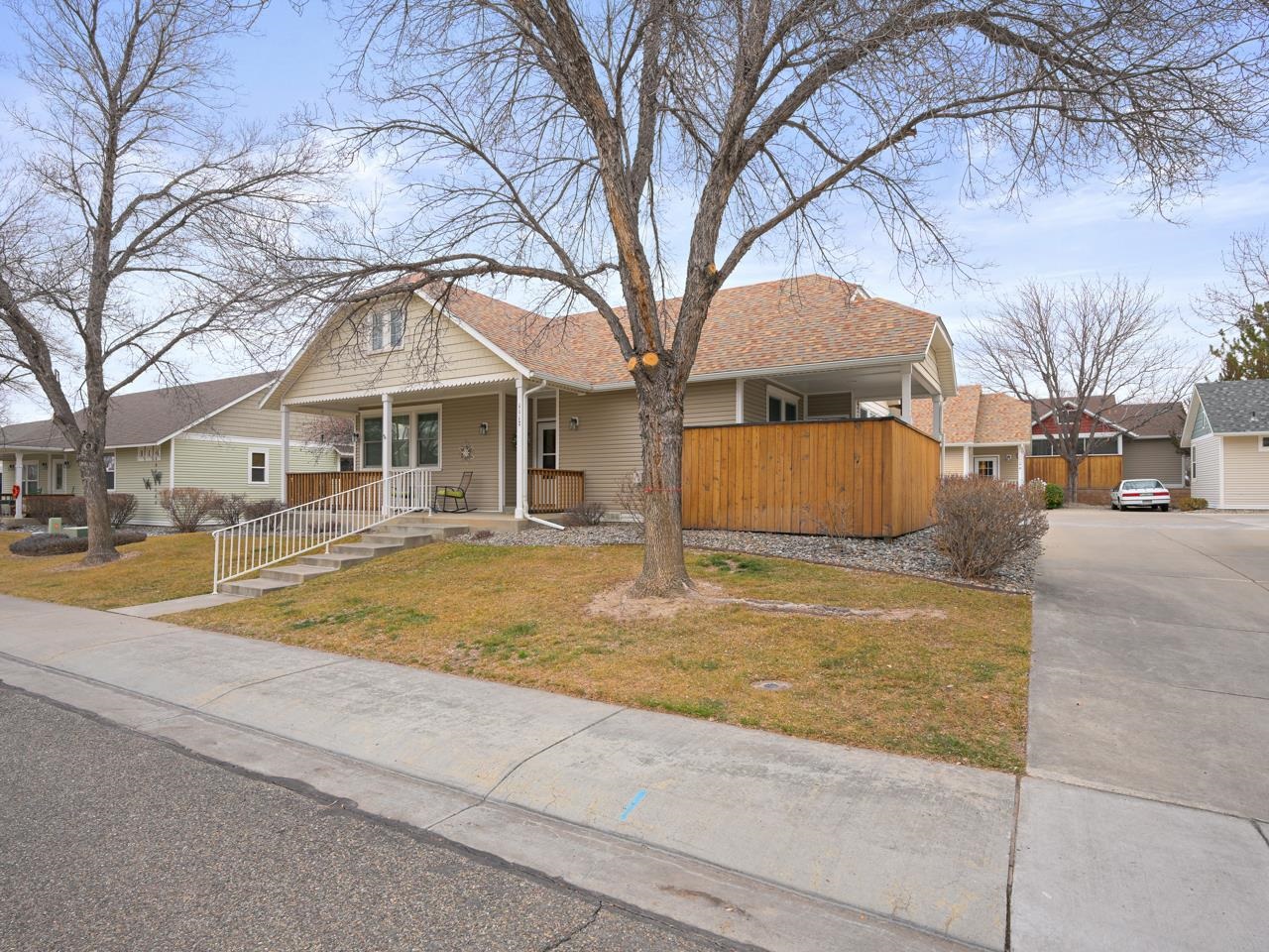 1117 Buttercup Lane Fruita, CO 81521 - Photo 3 of 25 a blue swimming pool with a barbeque and large trees