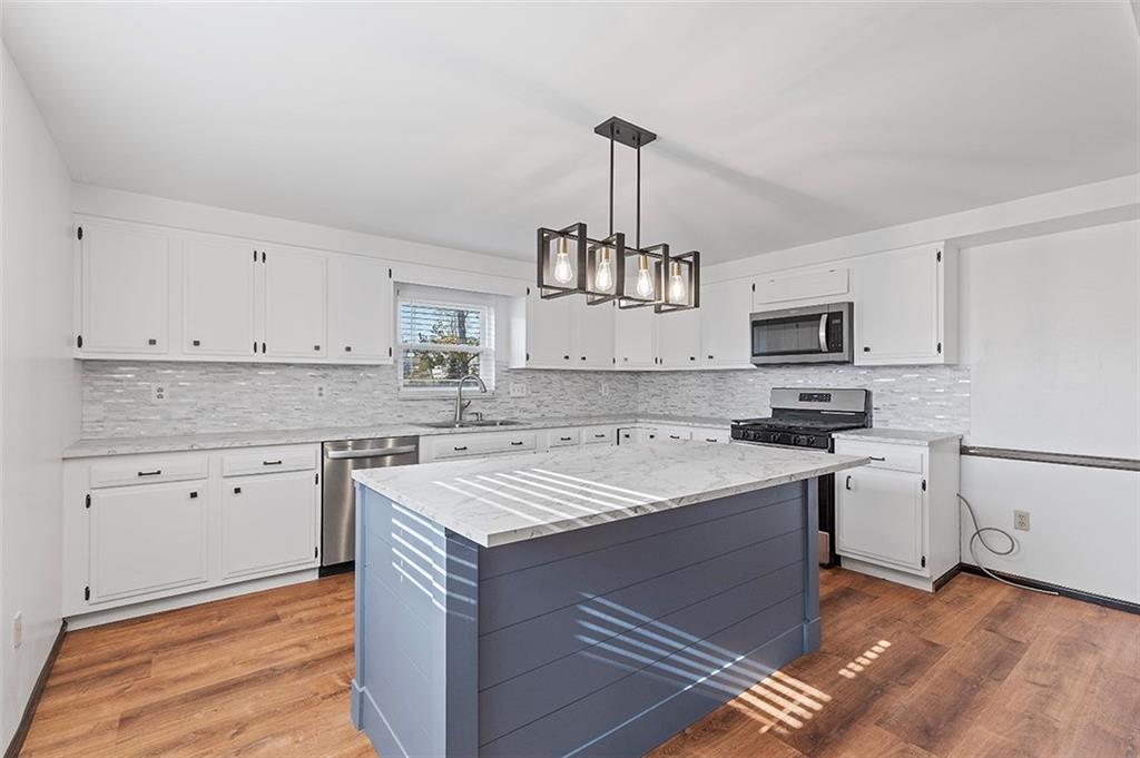 5018 Grove Road Pittsburgh, PA 15234 - Photo 18 of 41 a kitchen with stainless steel appliances granite countertop a sink stove and refrigerator