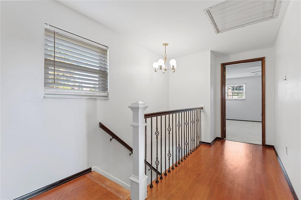 5018 Grove Road Pittsburgh, PA 15234 - Photo 23 of 41 a view of a hallway with wooden floor and staircase