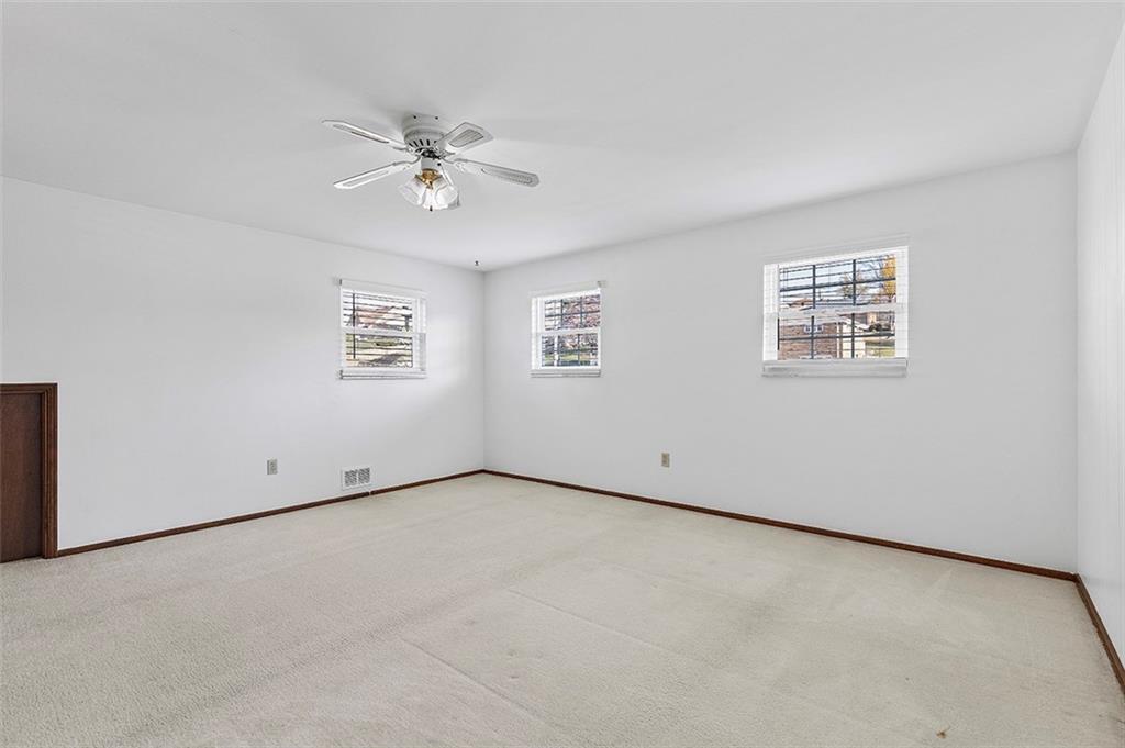 5018 Grove Road Pittsburgh, PA 15234 - Photo 26 of 41 an empty room with a window and a ceiling fan