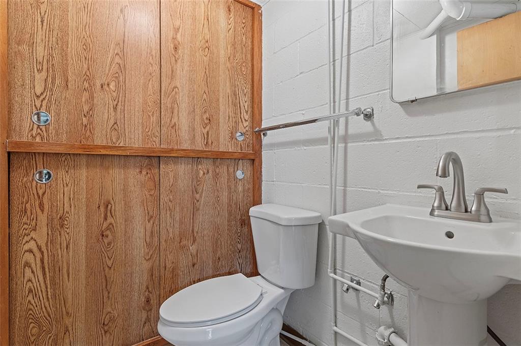 5018 Grove Road Pittsburgh, PA 15234 - Photo 31 of 41 a white toilet sitting next to a bathroom sink