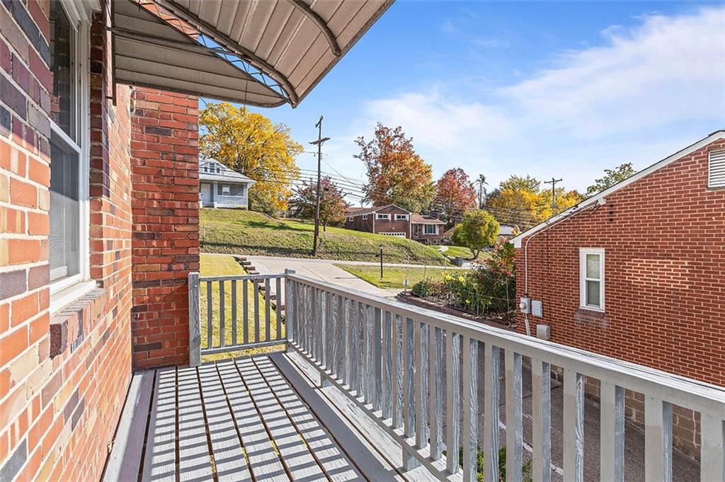 5018 Grove Road Pittsburgh, PA 15234 - Photo 40 of 41 a view of a balcony with wooden floor and fence