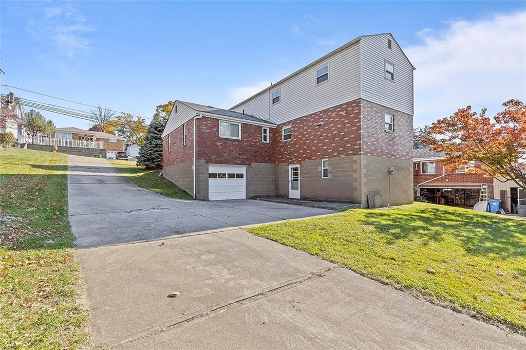 5018 Grove Road Pittsburgh, PA 15234 - Photo 5 of 41 a front view of a house with a yard