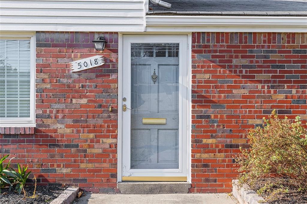 5018 Grove Road Pittsburgh, PA 15234 - Photo 9 of 41 a brick building with a window and a door