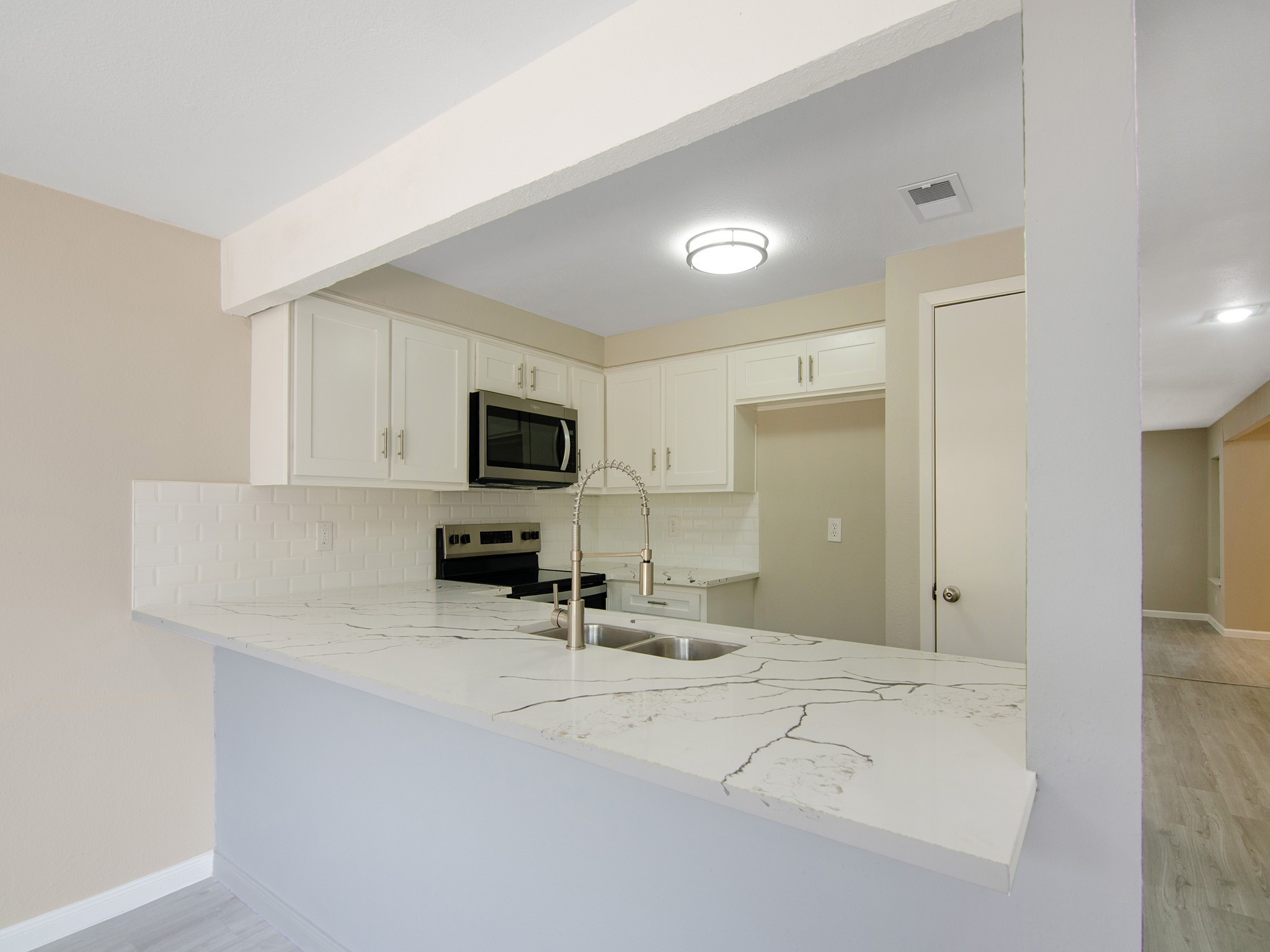11624 Village Pl Drive, Unit 327 Houston, TX 77077 - Photo 11 of 24 a view of a kitchen with microwave and cabinets