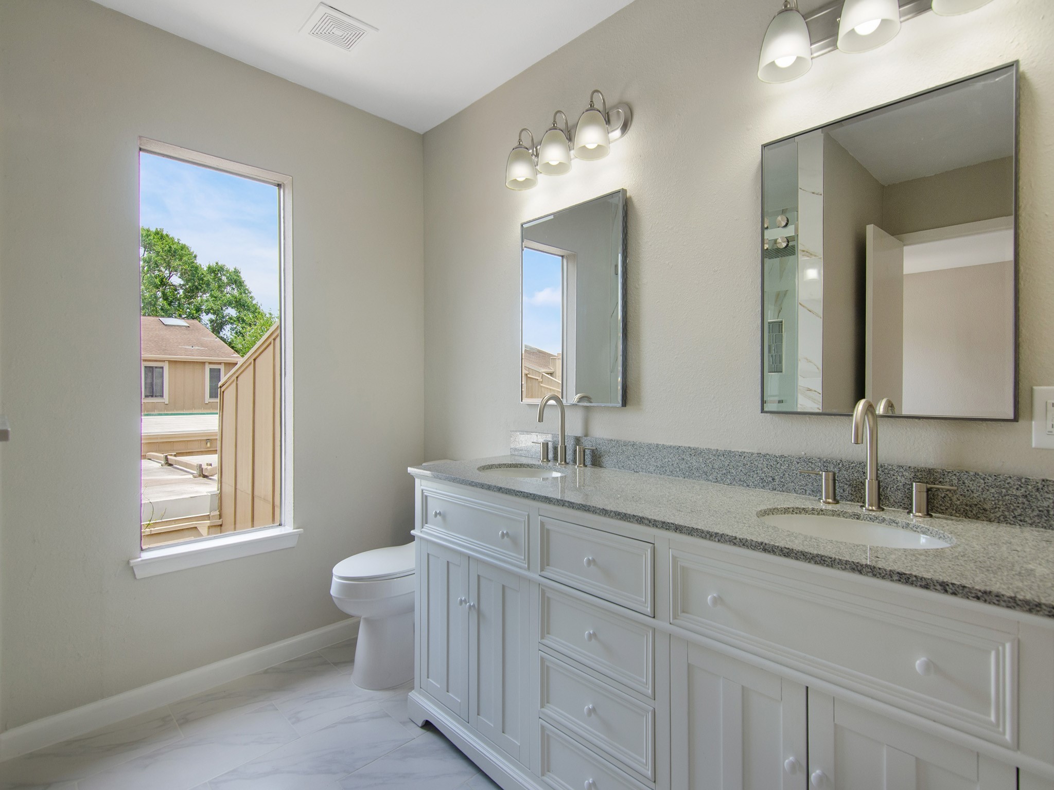 11624 Village Pl Drive, Unit 327 Houston, TX 77077 - Photo 17 of 24 a bathroom with 2 sink toilet and a mirror