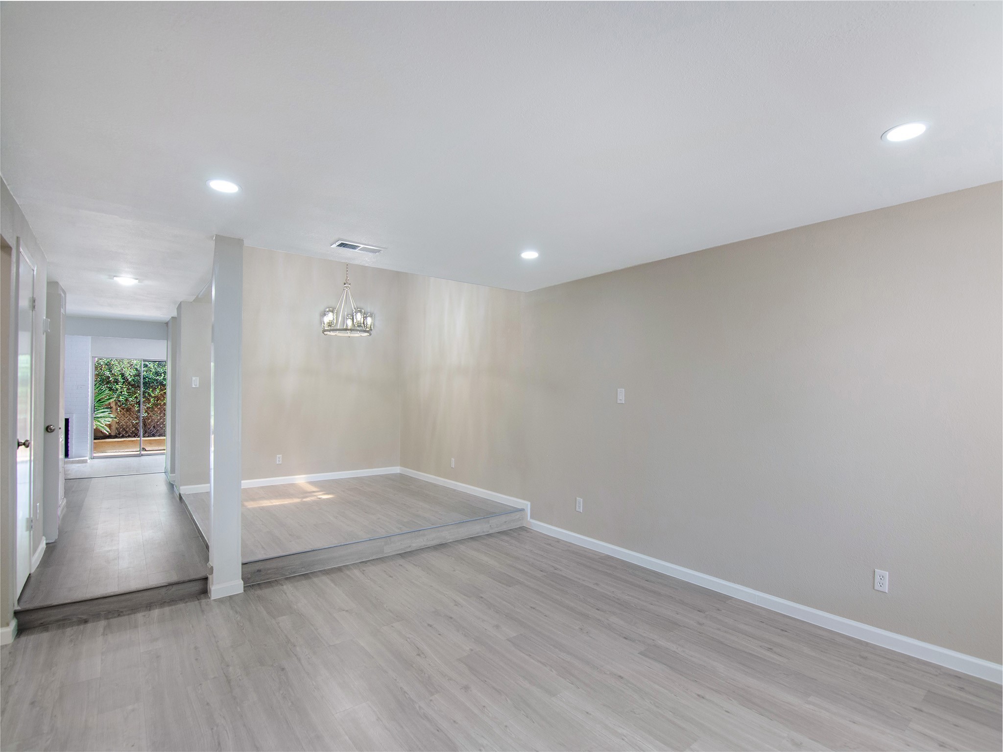 11624 Village Pl Drive, Unit 327 Houston, TX 77077 - Photo 4 of 24 an empty room with wooden floor and windows
