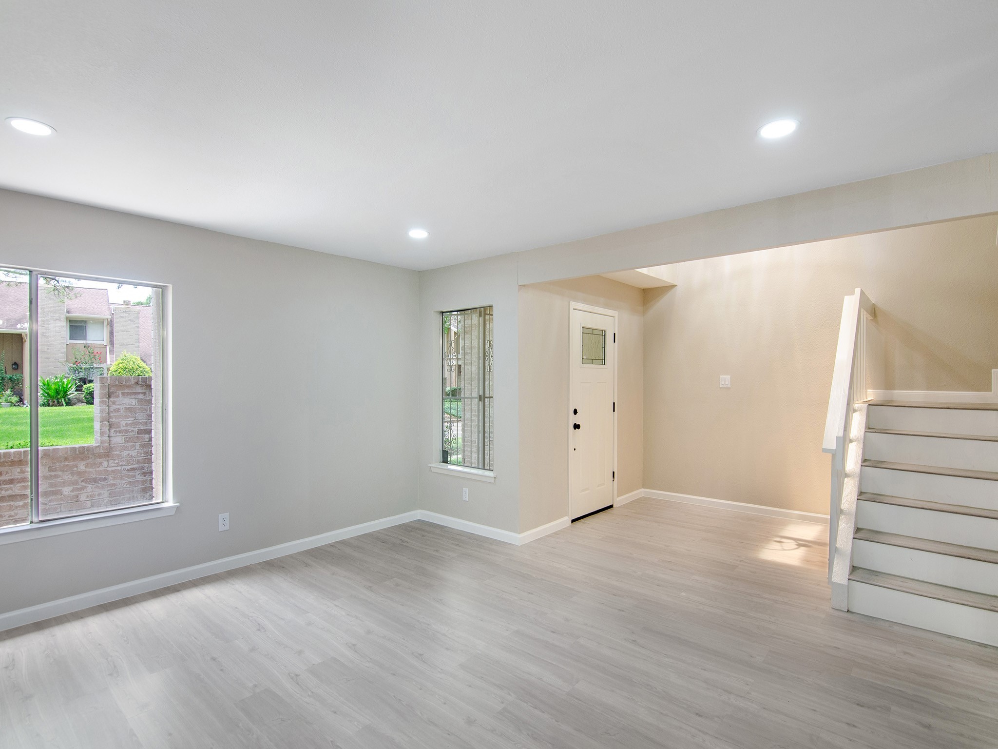 11624 Village Pl Drive, Unit 327 Houston, TX 77077 - Photo 6 of 24 an empty room with wooden floor and windows